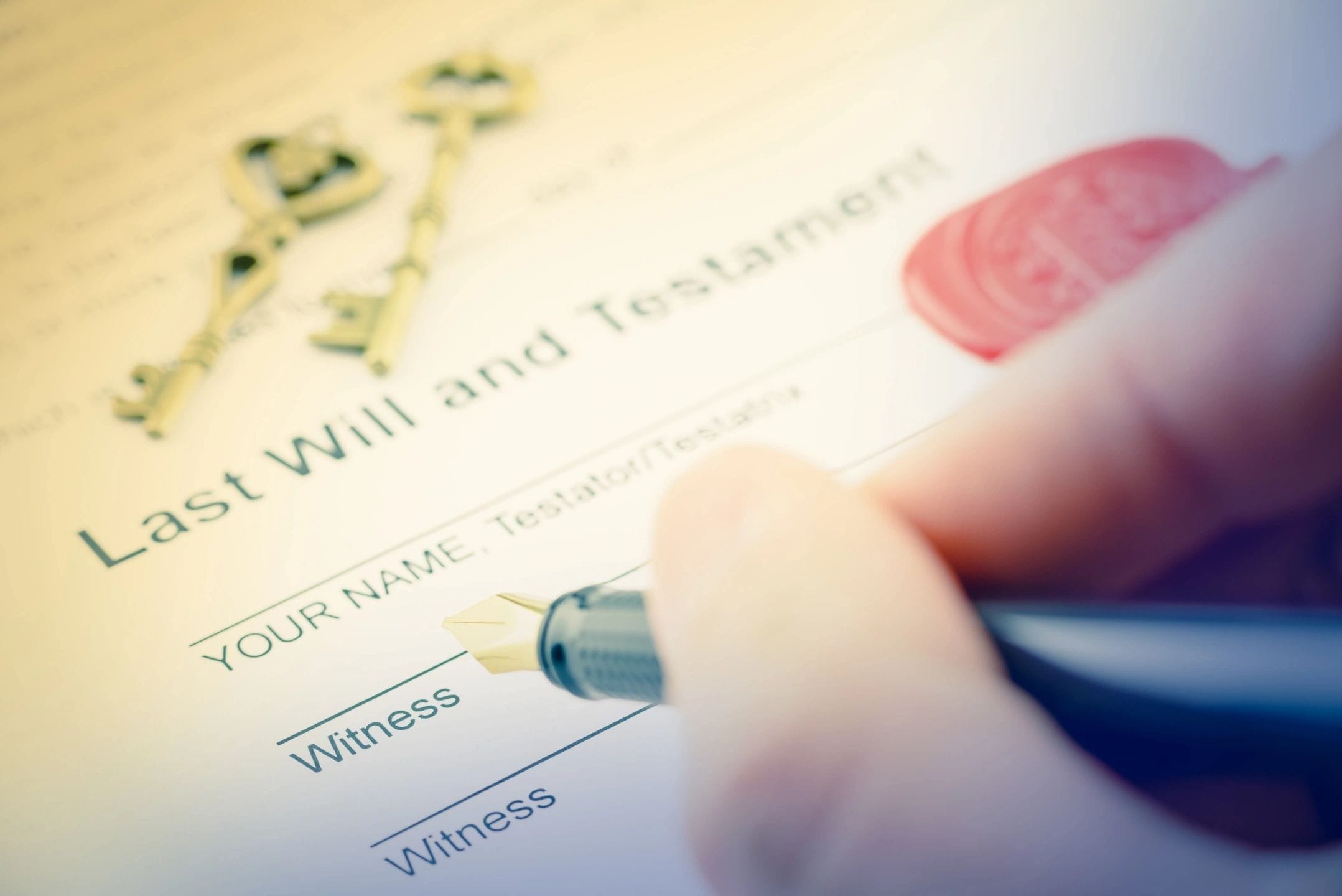 A person writing on the will and testament